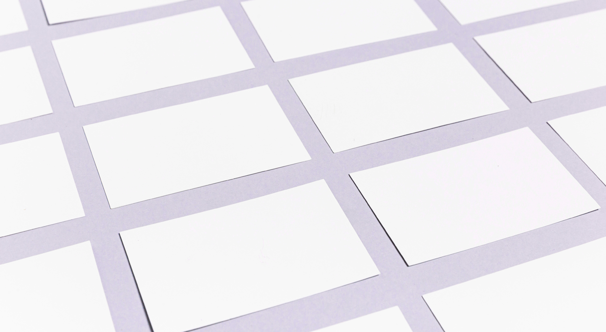 blank white business cards arranged in a grid on a light purple background