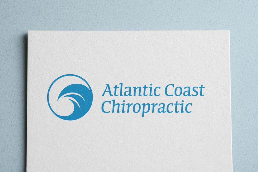 A white sheet of paper printed with the Atlantic Coast Chiropractic logo sits on a light blue background. The logo features a blue stylized wave inside a circle to the leff of the words 'Atlantic Coast Chiropractic' (also blue).