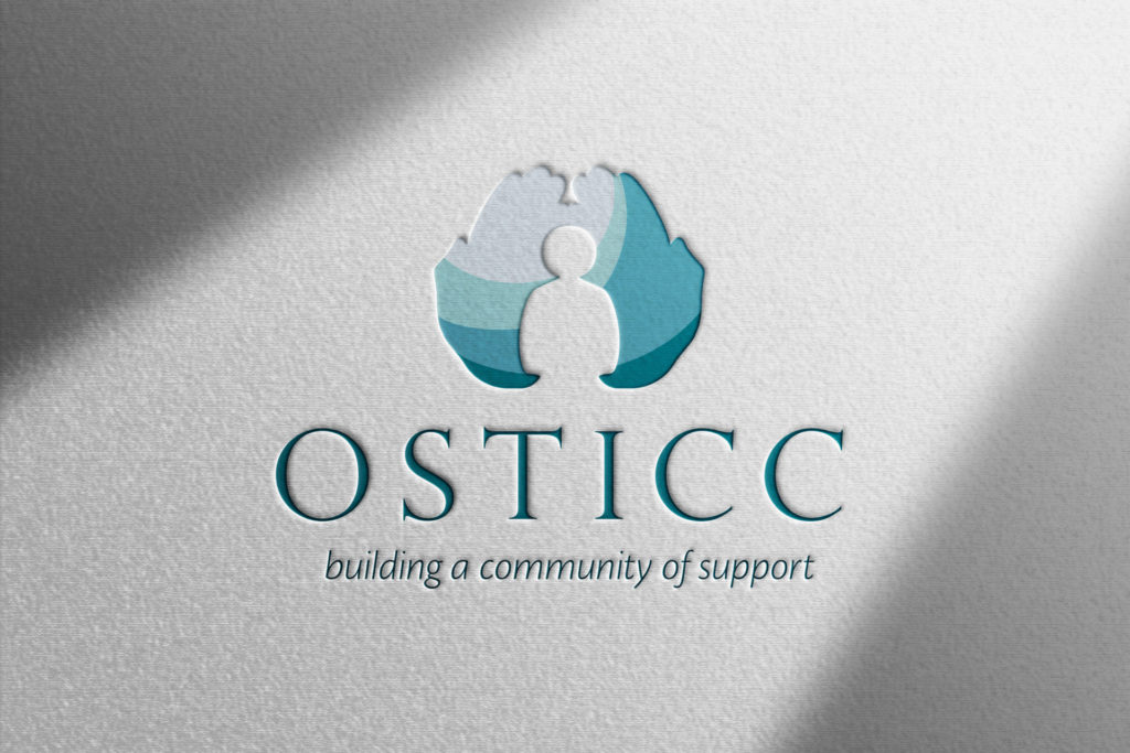 a photo of a letterpress imprint of the OSTICC logo on a white paper with dramatic diagonal shadows across two corners.