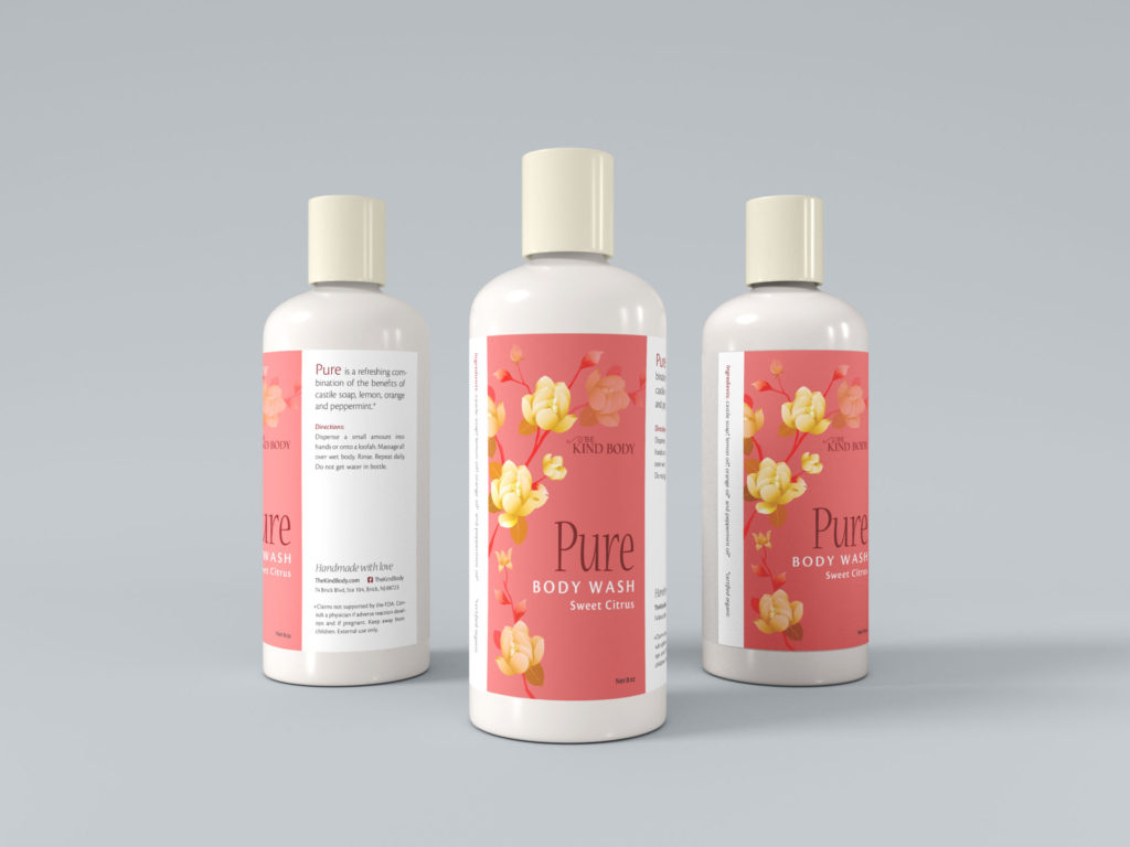 three large body wash bottles sit on a pale gray background. Each white bottle has a cream colored cap and a salmon pink product label with yellow flowers and burgundy print.
